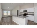 Bright kitchen with stainless steel appliances and center island with sink and breakfast bar at 37035 Sagemoor Dr, Zephyrhills, FL 33541
