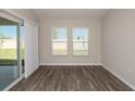 Sun-filled living room with hardwood floors and sliding glass door leading to the patio at 37035 Sagemoor Dr, Zephyrhills, FL 33541