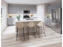 Bright kitchen featuring gray cabinets, stainless steel appliances, and a center island with barstool seating at 37049 Sagemoor Dr, Zephyrhills, FL 33541
