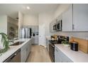 Modern kitchen featuring stainless steel appliances, gray cabinets, and sleek countertops with stylish decor at 37049 Sagemoor Dr, Zephyrhills, FL 33541