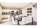 Open-concept kitchen and dining area with white cabinetry, stainless steel appliances and views of the backyard at 37061 Sagemoor Dr, Zephyrhills, FL 33541