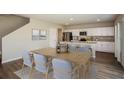 Bright, open-concept kitchen and dining room features modern appliances and a neutral color palette at 37061 Sagemoor Dr, Zephyrhills, FL 33541