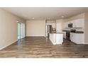 Open concept kitchen featuring stainless steel appliances and an island with sink at 37222 Sagemoor Dr, Zephyrhills, FL 33541