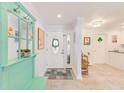 Bright entryway with a decorative mirror and bench, tiled floor, and white door at 4212 Mill Valley Ct, Tampa, FL 33618