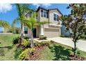 Well-maintained two-story home featuring a two-car garage and freshly landscaped front yard at 4513 Eternal Prince Dr, Sun City Center, FL 33573