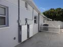 Side view of the house showcasing its clean exterior, windows, and outdoor electrical infrastructure at 4529 W Knox St, Tampa, FL 33614