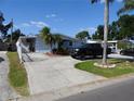 Charming single-story home with a well-maintained lawn and a long driveway leading to the house at 4529 W Knox St, Tampa, FL 33614