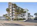 Condominium complex showcasing well-maintained landscaping, ample parking, and a contemporary design with balconies at 4823 Ebbtide Ln # 304, Port Richey, FL 34668