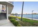Tranquil waterfront view with lush landscaping and stairs leading to the condominiums, providing scenic beauty at 4823 Ebbtide Ln # 304, Port Richey, FL 34668