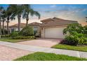 Beautiful single Gathering home with a tile roof, two-car garage and a red brick driveway at 4917 Sandy Brook Crk, Wimauma, FL 33598