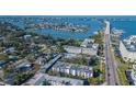 Aerial view of condominium complex with beautiful waterway and bridge at 55 Harbor View Ln # 108, Belleair Bluffs, FL 33770