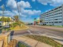 Street view of condo building with manicured green space in a beautiful area at 55 Harbor View Ln # 108, Belleair Bluffs, FL 33770