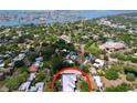 Aerial view of the property with a new silver roof, mature trees, in a waterfront neighborhood at 6920 Bougainvilla S Ave, St Petersburg, FL 33707