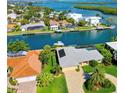 Waterfront property with a private pool and boat dock, surrounded by lush landscaping and canals at 781 Binnacle Point Dr, Longboat Key, FL 34228