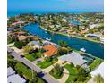 Stunning waterfront home with a pool and lush landscaping, nestled in a canal community at 781 Binnacle Point Dr, Longboat Key, FL 34228