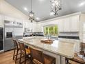 Bright kitchen with a large island, granite countertops, stainless steel appliances and barstool seating at 876 Ranch Rd, Tarpon Springs, FL 34688