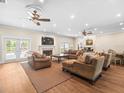 Spacious living room featuring a fireplace, hardwood floors, and comfortable furniture at 876 Ranch Rd, Tarpon Springs, FL 34688