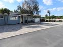 Charming home featuring a covered patio with chairs and an extended brick paved driveway, offering curb appeal and outdoor living at 8822 Rocky Creek Dr, Tampa, FL 33615