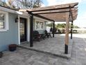 Close-up of the patio with a pergola and chairs, showcasing the outdoor living space and charming details at 8822 Rocky Creek Dr, Tampa, FL 33615