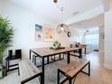 Bright dining room with wooden table, modern chairs, and stylish decor, perfect for gatherings at 9948 51St N Ave, St Petersburg, FL 33708