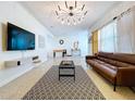 Bright living room with modern lighting, a comfortable sofa, and a stylish rug that enhance the space at 9948 51St N Ave, St Petersburg, FL 33708