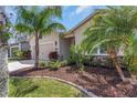 Attractive home with a well-kept lawn, stone accents, and mature landscaping at 11142 Spring Point Cir, Riverview, FL 33579