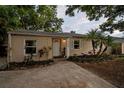 Charming single-story home featuring a well-manicured front yard with lush landscaping and a welcoming front door at 130 41St Ne Ave, St Petersburg, FL 33703