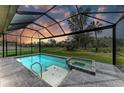 Inviting screened-in pool and spa with a peaceful view of nature, perfect for relaxing at 13034 Bliss Loop, Bradenton, FL 34211