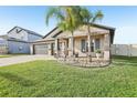 Charming single-story home featuring a three-car garage and a neatly manicured front lawn at 14413 Seattle Slew Ln, Ruskin, FL 33573