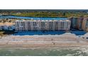 A scenic aerial view showcasing the beachfront condo building with pristine beach access at 18650 Gulf Blvd # 601, Indian Shores, FL 33785