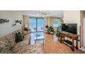 Bright living room with sliding glass door to the ocean-view balcony and coastal decor at 18650 Gulf Blvd # 601, Indian Shores, FL 33785