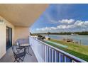 Balcony view of the community shuffleboard, dock, and water at 19451 Gulf Blvd # 211, Indian Shores, FL 33785
