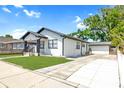 This home boasts a long driveway leading to a detached garage, surrounded by lush greenery at 2511 W Braddock St, Tampa, FL 33607