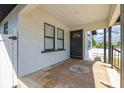 Inviting front porch with decorative tile, painted brick, and a dark front door at 2511 W Braddock St, Tampa, FL 33607