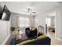 Cozy living room with natural light, ceiling fan, and neutral decor at 2511 W Braddock St, Tampa, FL 33607