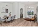 Dining room with hardwood floors, neutral decor, and access to the pool area at 3728 Cypress Meadows Rd, Tampa, FL 33624