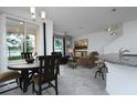 Open-concept space with a dining area and living room featuring stylish decor and ample natural light at 3844 Silverlake Way, Wesley Chapel, FL 33544