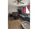 Bright living room with comfortable furniture, a decorative rug, and a view of the outside at 4581 Deltona Blvd, Spring Hill, FL 34606