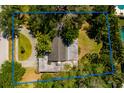 Aerial view of the house with driveway and mature landscaping surrounding the property at 459 Bayview Ne Dr, St Petersburg, FL 33704