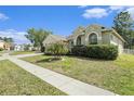 Beautifully landscaped home featuring green lawn, mature trees, and a cozy residential setting at 4656 Copper Hill Dr, Spring Hill, FL 34609