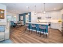 Open-concept kitchen and dining area with a center island, pendant lighting, and stainless steel appliances at 5597 Bay Tide Ct, Land O Lakes, FL 34638