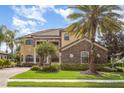 Charming two-story home with a stone facade, manicured lawn and mature trees for added curb appeal at 5656 Cloverleaf Run, Bradenton, FL 34211