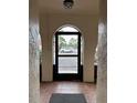 Inviting entryway showcases a tile floor and a door with an arched transom that provides views of the parking area at 6408 Bonnie Bay N Cir, Pinellas Park, FL 33781