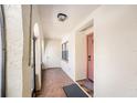 A quaint and charming entryway featuring neutral walls, tile flooring, and natural light that fills the space at 6408 Bonnie Bay N Cir, Pinellas Park, FL 33781