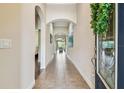 Welcoming foyer with tiled flooring, arched doorways, and a decorative wreath enhancing the entrance at 6642 Current Dr, Apollo Beach, FL 33572