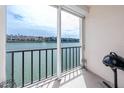 Balcony view of the water, grill and neighborhood, perfect for relaxing and enjoying the waterfront scenery at 7645 Sun Island S Dr # 304, South Pasadena, FL 33707