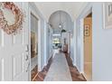 Welcoming entryway with wood floors and soft blue walls lead into the spacious living areas at 9375 French Quarters Cir, Weeki Wachee, FL 34613