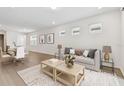 Bright, open-concept living room with modern furnishings and hardwood floors at 9408 Coastline Way, Parrish, FL 34219