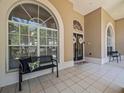 Bright entryway with large windows, tiled floors, and decorative door wreaths at 1084 Berkshire Ln, Tarpon Springs, FL 34688