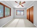 Bright bedroom features carpet, natural lighting, and closet space at 18906 Crescent Rd, Odessa, FL 33556